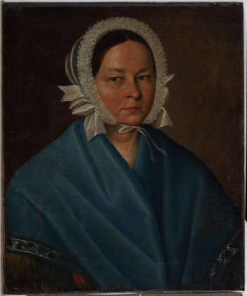 На коричневом фоне изображена погрудно женщина средних лет в белом чепце. На плечах темно-голубая шаль.